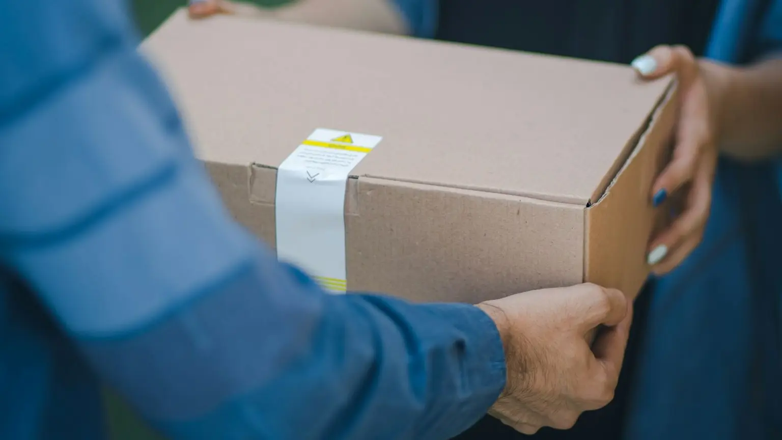 person giving brown box